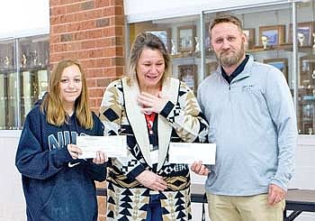 LUHS class presents checks to local breast cancer survivor