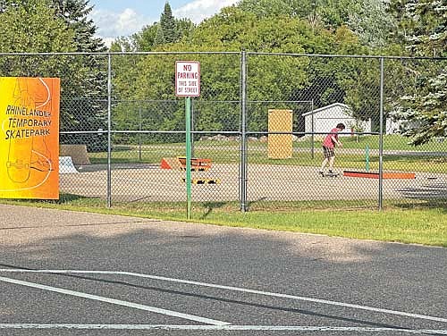 A lone skater practices skills Thursday evening, July 13, 2023, at the temporary skate park located in Rhinelander’s Hodag Park. The temporary facility will be available to skaters until Oct. 1. The City of Rhinelander and partners are planning to build a permanent skate park to be located at Pioneer Park. (Photo by Heather Schaefer/River News)