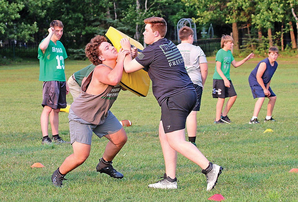 Reid Schultz, left, and Lucas Bishop, right, work on a blocking drill during the Hawgs & Dawgs one-day Wing-T lineman camp in Rhinelander Thursday, July 13. Hodag football head coach Aaron Kraemer said the Hodags do plan to run a variant of the Wing-T this year, which comes with a different blocking scheme than the team had the past several seasons in a pro-style offense. (Bob Mainhardt for the River News)