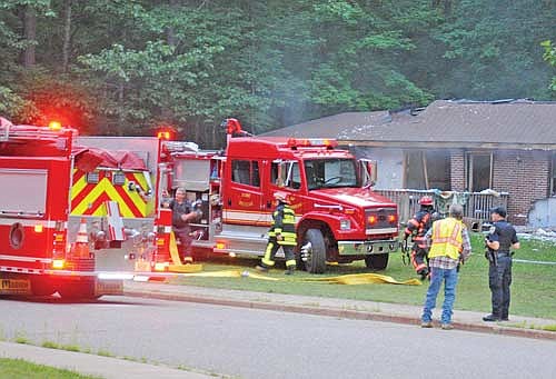 Firefighters from Lac du Flambeau, Woodruff and Arbor Vitae responded to a call Tuesday, July 18 reporting a house on Makwa Trail in Lac du Flambeau had sustained an explosion which blew a hole in the roof, caused other damage and resulted in a fire in the basement. No one was injured. Mike Zimmerman with the Lac du Flambeau fire department said Wednesday an investigator with the state fire marshal’s office was called in to establish a cause for the explosion. (Photo by Brian Jopek/Lakeland Times)