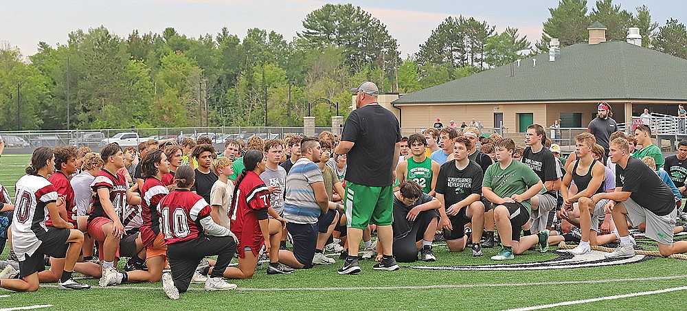 Rhinelander High School football coach Aaron Kraemer talks with players from Rhinelander and Crandon following the end of Hodag Football Team Camp at Mike Webster Stadium Wednesday, July 19. The two schools held joint summer sessions for the second straight year. Rhinelander traveled to Crandon on Tuesday and Crandon traveled to Rhinelander on Wednesday. (Bob Mainhardt for the River News)