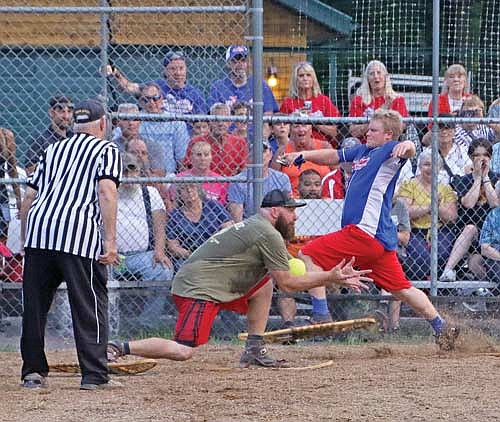 Dustin Schowalter comes to home plate as Zimmy’s Brett Nastala looks to make an out Monday, July 24 at Snowshoe Park in Lake Tomahawk. (Photo by Dean Hall/Lakeland Times)