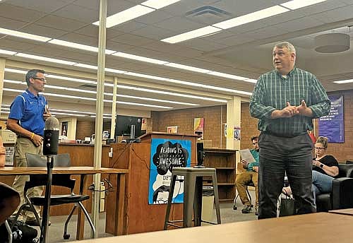 Lakeland Union High School district administrator Bob Smudde, right, and Stevens Point-based Point of Beginning owner Scott Groholski, left, present to the district’s board of education different price estimates for the community complex project on Monday, July 24, in Minocqua. (Photo by Trevor Greene/Lakeland Times)