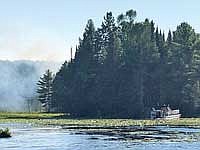 Firefighters with the DNR and Arbor Vitae are given a boat ride to a fire in the Northern Highlands American Legion State Forest near Pickerel Lake on Wednesday, July 26, in St. Germain. (Submitted photo)