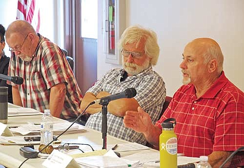 Oneida County supervisors, from the left, Mike Timmons and Bob Almekinder, members of the county board’s planning and development committee, listen to committee chairman Scott Holewinski address Minocqua Brewery Company owner Kirk Bangstad during a public hearing on Wednesday, Aug. 2, at the Woodruff Town Hall. (Photo by Brian Jopek/Lakeland Times)