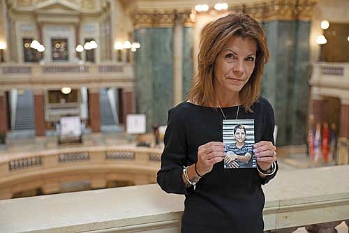Sheila Lockwood holds a photo of her late son, Austin, in the Wisconsin State Capitol in Madison. In 2018, Austin, 23, was riding in the passenger seat of a drunk driver’s vehicle in Three Lakes. The driver smashed into a tree, killing Austin. (Photo by Drake White-Bergey/ Wisconsin Watch)