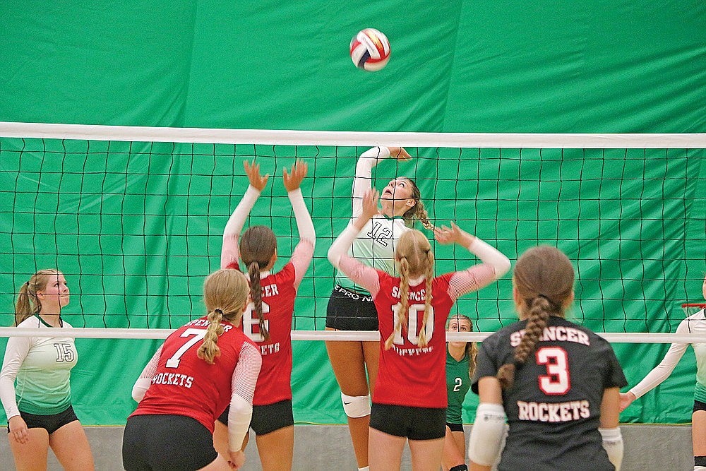Rhinelander’s Callie Hoerchler goes up for an attack against Spencer’s Carmen Krause (6) and Autumn Davis (10) during a non-conference volleyball match in the Hodag Dome Tuesday, Aug. 22. Hoerchler had a team-high 13 kills as the Hodags won two of three matches in their season-opening invite. (Jeremy Mayo/River News)