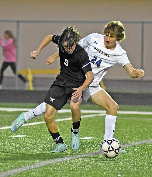 Cam Bernard (9) battles for the ball with Rice Lake’s Braeden Kretzchmar during the second half Thursday, Aug. 24 at IncredibleBank Field in Minocqua. Bernard won the ball, leading to a Yaroslav Myshchyshyn goal. (Photo by Brett LaBore/Lakeland Times)