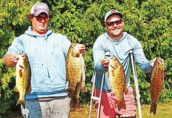 Brendan Garrigan (left) and Kyle Martinson took first place in the Fifth Annual Rod Gaskill Memorial Bass Tournament on Boom Lake with 19.84 pounds. (Photo by Beckie Gaskill/Lakeland Times)