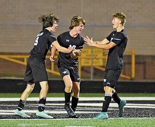 Brett Peterson, middle, celebrates his first career varsity goal with Cam Bernard, left, and Sawyer Brown in the second half against Northland Pines Tuesday, Aug. 29 at IncredibleBank Field in Minocqua. (Photo by Brett LaBore/Lakeland Times)