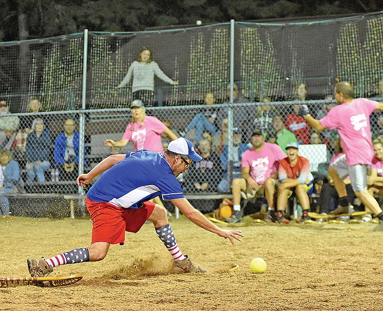 Nick Merckz picks up the ball as Lake Tom Tap House’s Nick Pitterle runs down the first base line in the ninth inning of the Snowhawks’ 25-8 win Monday, Aug. 28 at Snowshoe Park in Lake Tomahawk. (Brett LaBore/Lakeland Times)