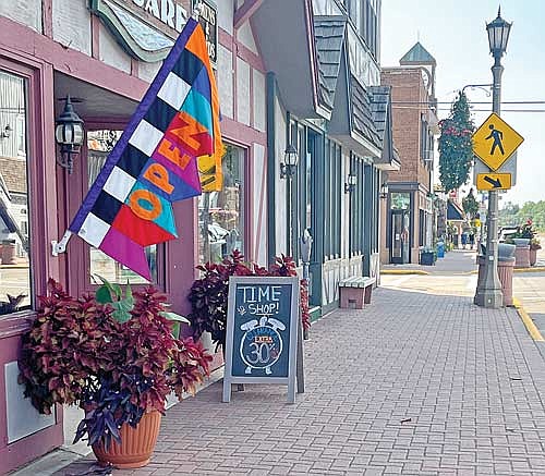 Alleged Oneida County zoning violations — including benches, sandwich board signs and flower planters — are seen throughout downtown on Friday, Sept. 1, in Minocqua. (Photo by Trevor Greene/Lakeland Times)