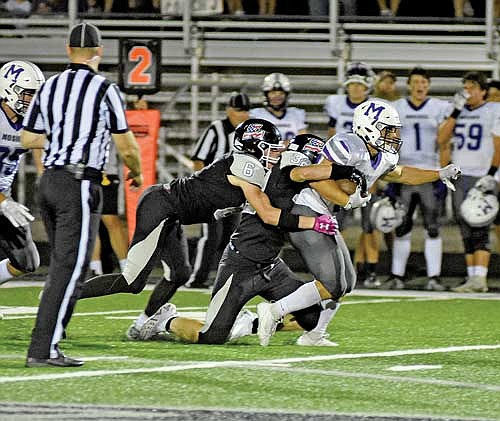 Tyson Skubal (6) and Nate Ariola (32) take down Mosinee’s Wyatt Harris during the fourth quarter Friday, Sept. 1 at IncredibleBank Field in Minocqua. (Photo by Brett LaBore/Lakeland Times)