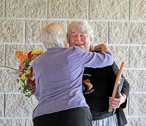 Northwoods Unitarian Universalist Fellowship social justice committee chairperson Nancy Johnson hugs Carol Amour, the recipient of the Martin Luther King Jr. humanitarian award, on Sunday, Aug. 27, in Minocqua. (Photo by Trevor Greene/Lakeland Times)