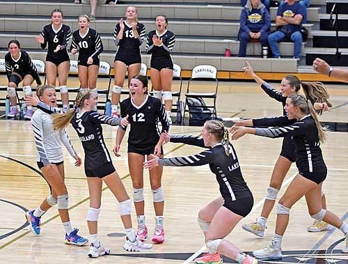 Players, from left, Kieran Petrie, Meela Khan (3), Meg Pfannerstill (12), Cale Quade, Sloane Timmerman and Stina Peterson celebrate a point in a match against Tomahawk Tuesday, Sept. 12 at the Lakeland Union High School fieldhouse in Minocqua. (Photo by Brett LaBore/Lakeland Times)