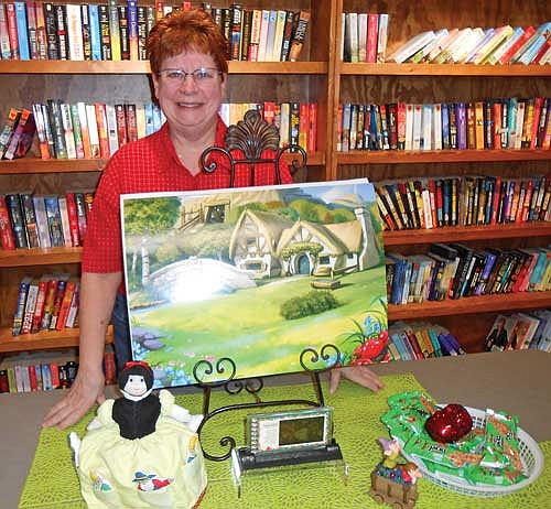 Dawn Brogle of Eagle River with her Snow White doll in a fairy take scene during her recent presentation on topsy-turvy dolls. (Contributed photograph)