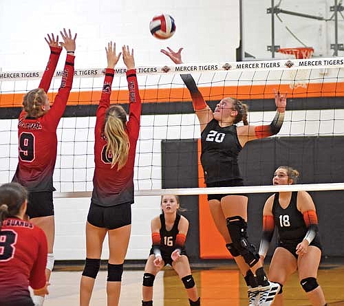 Jenny Klopatek tips the ball over the net for a point against the blocks of Washburn’s Ede Krueger (9) and Hermosa Gauthier (6) during the fourth set of a 3-1 Mercer win Thursday, Sept. 14 at John “JP” Pierpont Court in Mercer. (Photo by Brett LaBore/Lakeland Times)