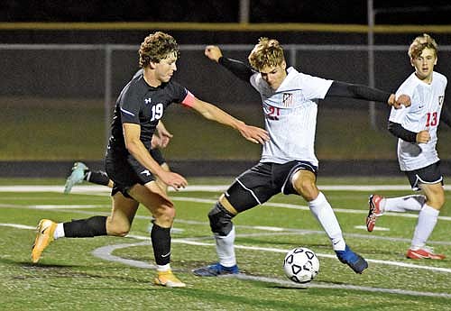 Yaroslav Myshchyshyn dribbles the ball past Washburn defender Javier Lebouton-Chediak on his way to a goal during the second half Monday, Sept. 18 at IncredibleBank Field in Minocqua. (Photo by Brett LaBore/Lakeland Times)