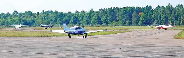 Four of the aircraft in the first flight at Saturday’s Young Eagles event at Lakeland Airport in Arbor Vitae taxi toward take-off position on the airport’s north-south runway. (Photo by Brian Jopek/Lakeland Times)