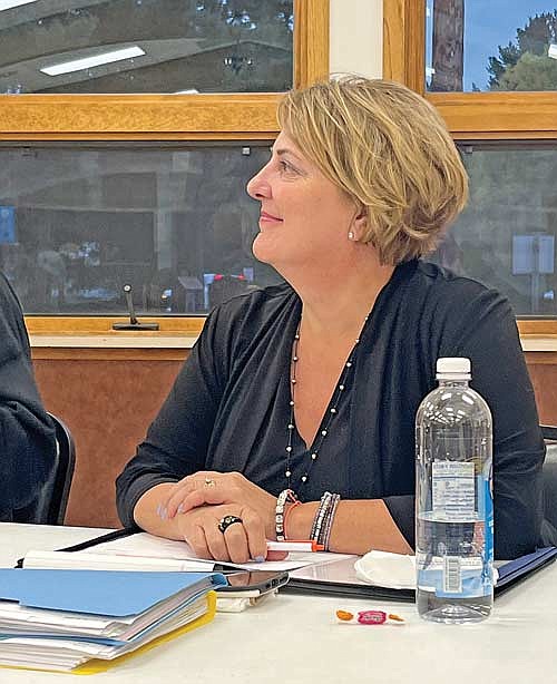 Manitowish Waters town supervisor Joan Farrell listens to town chairman John Hanson speak during a public hearing prior to her first town board meeting as supervisor on Tuesday, Sept. 12, in Manitowish Waters. (Photo by Trevor Greene/Lakeland Times)