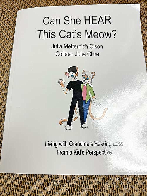 Pictured is the cover of “Can She HEAR This Cat’s Meow?” by Julia Metternich OIson and her granddaughter Colleen Julia Cline. (Photo by Heather Schaefer/River News)