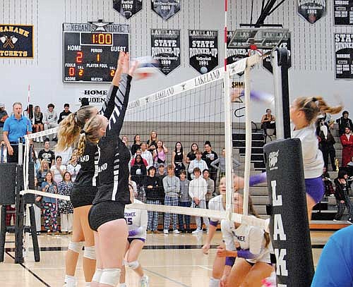 Stina Peterson, far side, and Cale Quade attempt to block the hit of a Mosinee attacker during the first set Thursday, Sept. 28 at the Lakeland Union High School fieldhouse in Minocqua. (Photo by Brian Jopek/Lakeland Times)