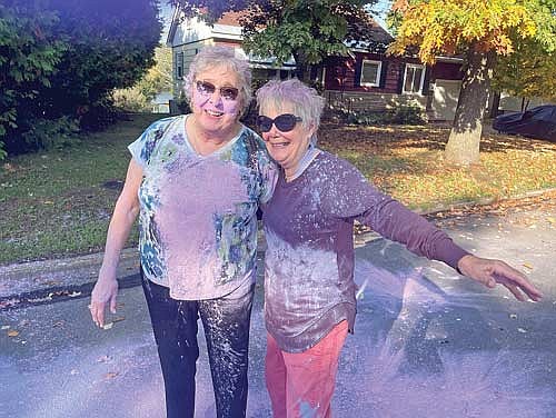 Ruth Schiek and Sharann Schoppe, both board members of the Tri-County Council on Domestic Violence and Sexual Assault, were covered in purple dust after participating in a 5K Color Run at Rhinelander’s Hodag Park Sunday, Oct. 1 in recognition of Domestic Violence Awareness Month. (Submitted photo)