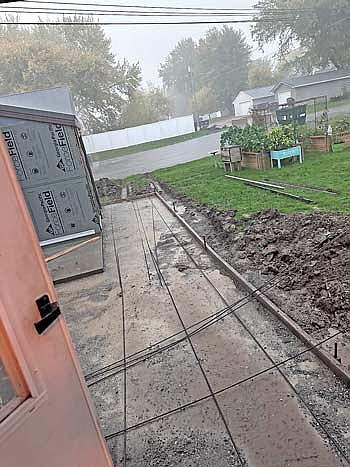 Of course, as we were finally ready for the rest of the concrete to be delivered, the sky opened up in a torrential downpour with 20 mile per hour winds. One delay after another has befallen this project. (Photo by Beckie Gaskill/Lakeland Times)