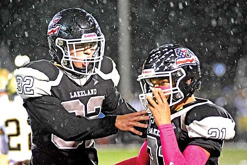 Nate Ariola, left, celebrates a tackle made by Talon Haling in the first quarter against Hayward Friday, Oct. 6 at IncredibleBank Field in Minocqua. (Photo by Brett LaBore/Lakeland Times)