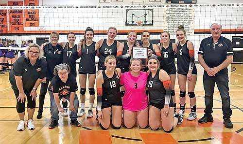 The Tigers are all smiles after winning their fifth straight conference title, first in the Northern Lights Conference, with a 3-0 win against Drummond Friday, Oct. 13 at John “JP” Pierpont Court in Mercer. Pictured, front from left, are coach Robyn Schoeneman, Megan Heyen, Rylinn Rossi, Ava Milashus, Amber Eith; back row, assistant coach Kelly Kohegyi, Kaylee Powers, Ona Ruiz, Eiley Schoeneman, Jenny Klopatek, Anya Brandenburg, Ryley Saarnio, Tyla Tourtillott and assistant coach Bob Schenk. (Contributed photograph)