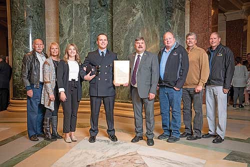 Rep. Rob Swearingen, center right, presents Tanner Perry of the Rhinelander Fire Department wit the 2023 “First Responder of the Year” award. (Submitted photo)