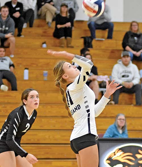 Kieran Petrie attacks the ball as Greta Johnson looks on in the third set of a WIAA Division 2 regional semifinal game against Oconto Falls Thursday, Oct. 19 at Oconto Falls High School. (Photo by Brett LaBore/Lakeland Times)