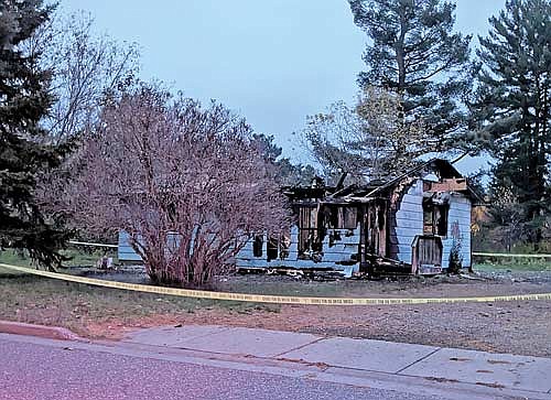 What’s left of an abandoned house on Was-Wa-Gon Street in Lac du Flambeau that caught fire Sunday night. (Photo by Dean Hall/Lakeland Times)