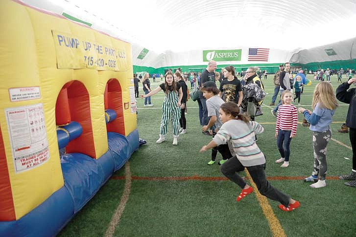 The School District of Rhinelander will host the second annual “Hodag Day at the Dome” on Wednesday, Dec. 6 at the Hodag Dome. The event, celebrating the Hodag’s 130th birthday, will include games and inflatables. Pictured: Children play on an inflatable during last year’s Hodag Day celebration. (River News file photo)