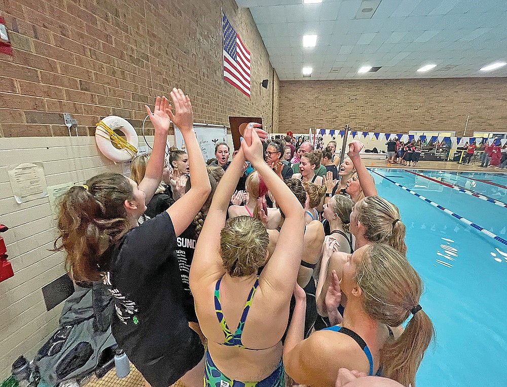 The Rhinelander High School girls’ swim team celebrates with the championship plaque after winning a WIAA Division 2 sectional in Merrill Saturday, Nov. 4. The Hodags won all 11 swimming events and took the title by 230 1/2 points over runner-up Rice Lake. (Jeremy Mayo/River News)