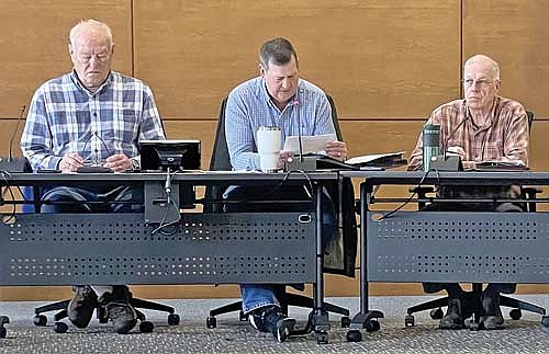 The chairman of the Vilas County board’s zoning committee, Mike Biszak, center, reads some of the correspondence received regarding the proposed tourist rooming house amendments during a Nov. 2 public hearing at the Vilas County courthouse in Eagle River. To his right is committee member Marv Anderson and to Biszak’s left, committee member Richard Logan. (Photo by Brian Jopek/Lakeland Times)