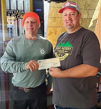 Pete Wetzler, left, is presented a check for $8,497 by Eric Behnke from funds raised by an Aug. 22 Whitetails Unlimited event held in Mercer. (Contributed image)