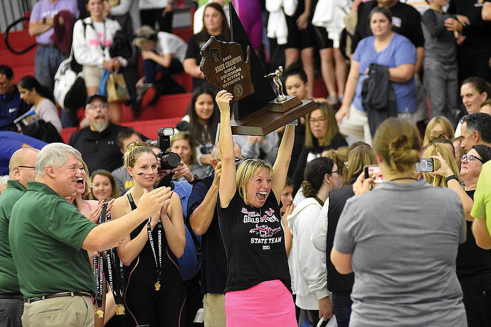 Rhinelander High School girls’ swim coach Jenny Heck hoists the trophy after the Hodags won the WIAA Division 2 state championship in Waukesha Friday, Nov. 10. Rhinelander won six events in the meet and swam to an 87-point victory over Whitefish Bay. It was Rhinelander second state championship in girls’ swimming, matching the feat the Hodags achieved in 2020. (Brett LaBore/Lakeland Times)