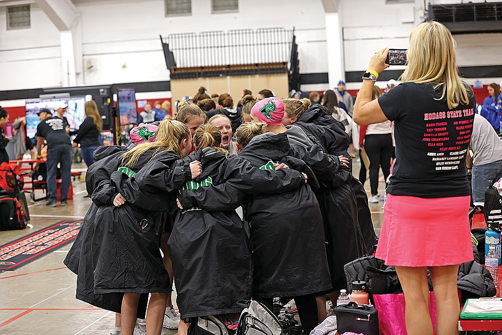 The Rhinelander High School girls’ swim team huddles prior to the start of the WIAA Division 2 state championship in Waukesha Friday, Nov. 10. (Bob Mainhardt for the River News)