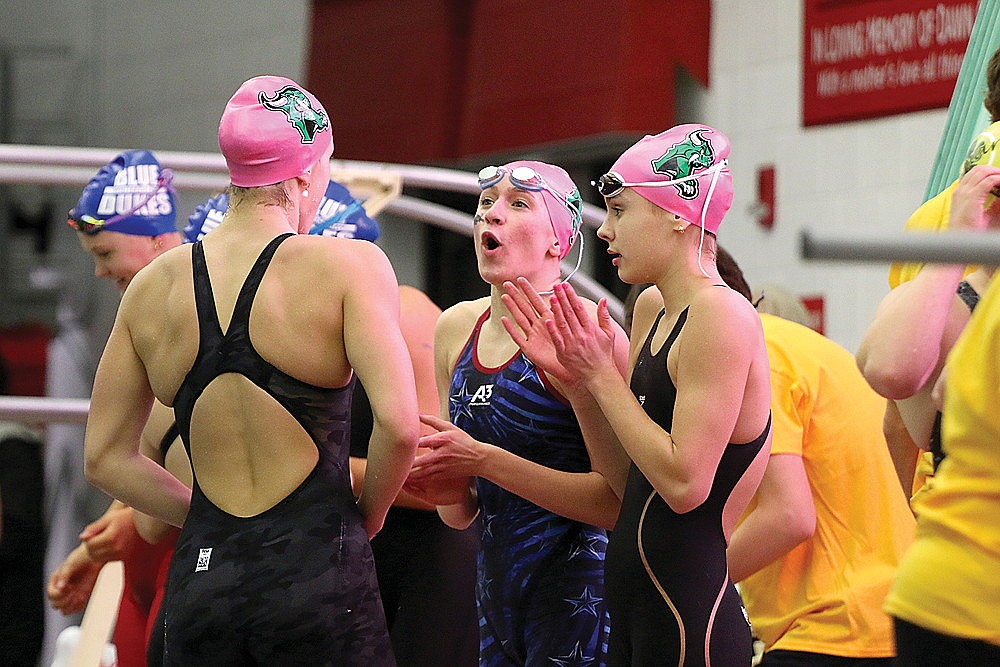 Rhinelander’s Vivian Lamers celebrates with teammates Karis Francis, left, and Celia Francis after the 400-yard freestyle relay during the WIAA Division 2 state championship in Waukesha Friday, Nov. 10. (Jeremy Mayo/River News)