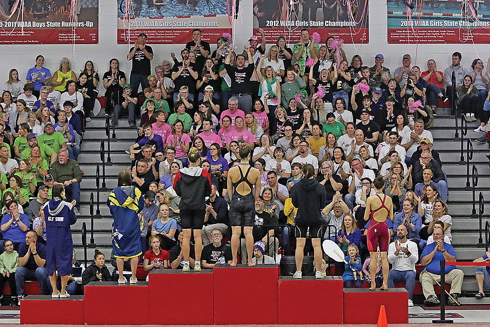 The Rhinelander fan section celebrates as Karis Francis stands on the top step of the podium following the 100-yard butterfly during the WIAA Division 2 state championship in Waukesha Friday, Nov. 10. (Jeremy Mayo/River News)
