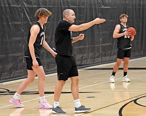 Coach Jacob Jarvensivu explains a drill with Hakken Berklund looking on during the first day of practice Monday, Nov. 13 at the Lakeland Union High School fieldhouse in Minocqua. (Photo by Brett LaBore/Lakeland Times)