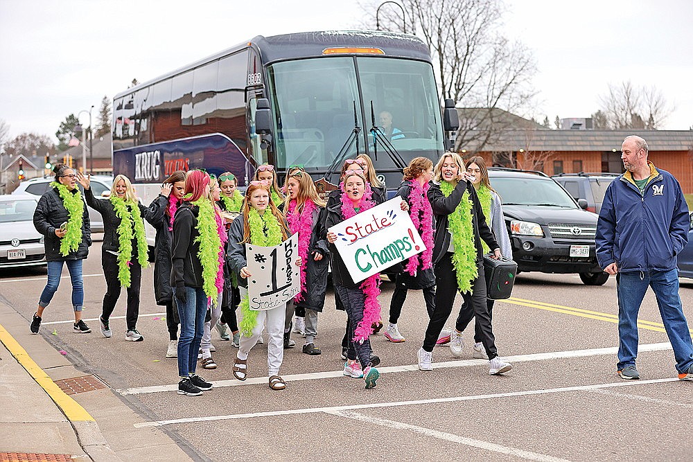 The Rhinelander High School girls’ swim team begins its march up Brown Street during an escort  celebrating the team’s WIAA Division 2 state championship Saturday, Nov. 11. (Bob Mainhardt for the River News)