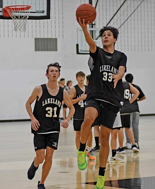 Taedyn Hernandez rises for a layup as Owen Clark (31) looks on during the first day of practice Monday, Nov. 13 at the Lakeland Union High School fieldhouse in Minocqua. (Photo by Brett LaBore/Lakeland Times)