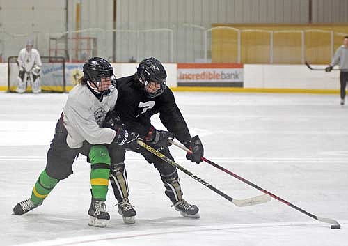 Kort Meyer, left, and Aaron Wanta battle for the puck during the first week of practice Wednesday, Nov. 8 at Lakeland Ice Arena in Minocqua. (Photo by Brett LaBore/Lakeland Times)