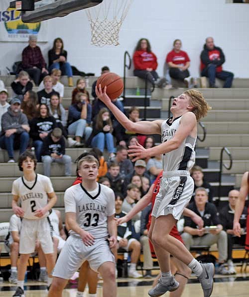 Danny Gahler attempts to make a layup as Nate Ariola (33) and Benny Gahler (2) look on in the second half of the season opener against Shawano Tuesday, Nov. 21 at Ted Voigt Court in Minocqua. Danny Gahler and Ariola led Lakeland with 13 points each. (Photo by Brett LaBore/Lakeland Times)