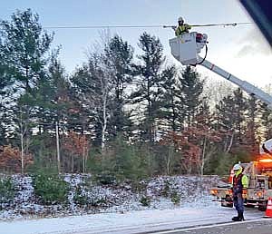 A crew from Wisconsin Public Service Monday afternoon repaired power lines that were struck by a boom on a Great Northern Tree Service truck as it drove on State Highway 70 on Minocqua’s west side. (Photo by Gregg Walker/Lakeland Times)