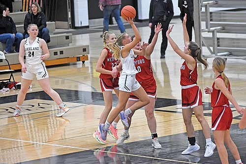 Ali Timmerman makes a basket with the foul against the defense of Medford players, from left, Taylor Klingbeil, Breanna Kraemer, Toryn Rau and Rylee Hraby in the first half Friday, Dec. 1 at Ted Voigt Court in Minocqua. Timmerman made the free throw to complete the 3-point play. (Photo by Brett LaBore/Lakeland Times)