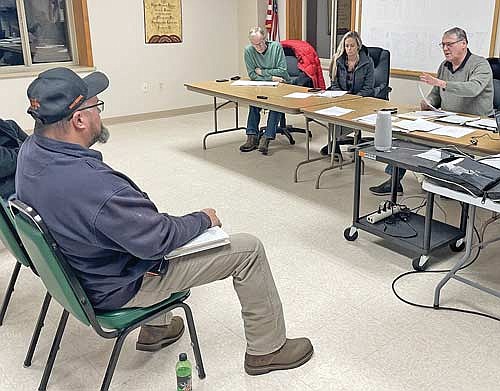 Crescent fire chief Keven Mahner, left, listens as Crescent town chairman Robb Jensen makes a point during the town board’s special meeting on Nov. 29. Also in the photo are town supervisors Kyla Waksmonski to Jensen’s immediate right and Mike Pazdernik. (Photo by Brian Jopek/Lakeland Times)
