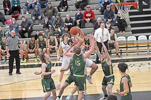 Noah Bruckner makes a runner in the lane against the defense of Chequamegon’s Robert Schienebeck (10), Anthony Morgan (15) and Isaiah Bourgard (12) in the first half of a 66-33 win Tuesday, Dec. 5 at Ted Voigt Court in Minocqua. (Photo by Brett LaBore/Lakeland Times)
